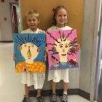 A Boy and Girl Holding Artworks of People