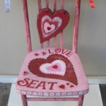 A Heart Shape Love Cushion on a Pink Chair One