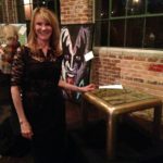 Gretchen Standing in Front of a Wooden Table